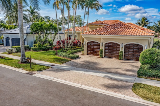 mediterranean / spanish-style home with a front lawn