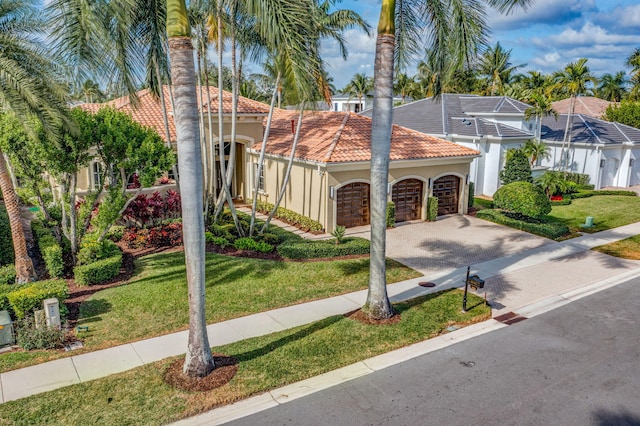 mediterranean / spanish home with a front yard, a garage, and a lanai