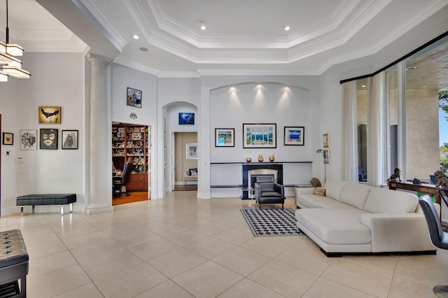 living room featuring light tile patterned floors, a raised ceiling, and ornamental molding