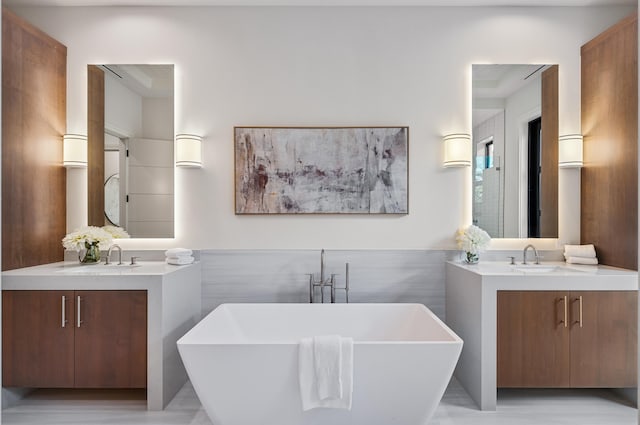 321 NW 7th St, Delray Beach, FL 33444 - full bath featuring two vanities, a freestanding tub, and wainscoting