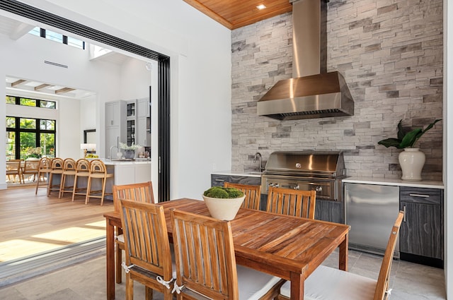 321 NW 7th St, Delray Beach, FL 33444 - dining area featuring wooden ceiling, a towering ceiling, and a wood stove