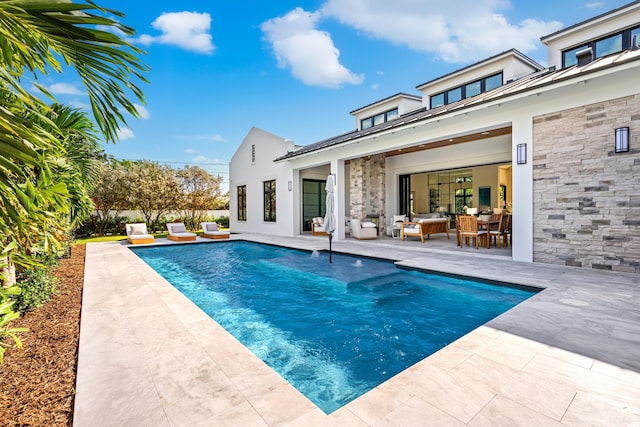 321 NW 7th St, Delray Beach, FL 33444 - view of swimming pool featuring a patio and an outdoor living space