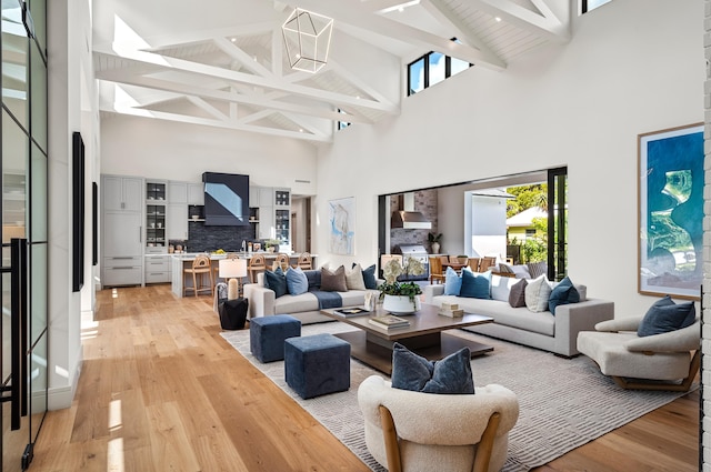321 NW 7th St, Delray Beach, FL 33444 - living room featuring high vaulted ceiling, light wood-style flooring, and beam ceiling