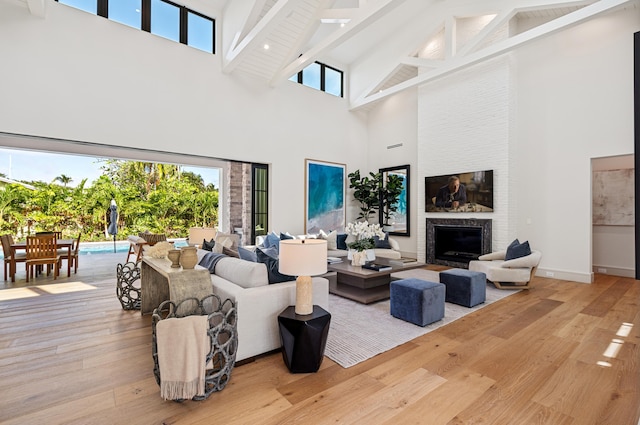 321 NW 7th St, Delray Beach, FL 33444 - living room with high vaulted ceiling, wood finished floors, beam ceiling, and a fireplace