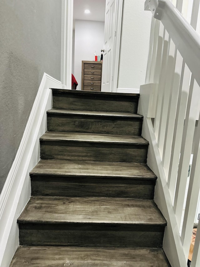 staircase with hardwood / wood-style floors