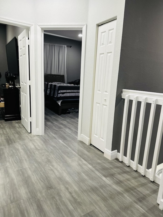 hallway with radiator heating unit and light wood-type flooring