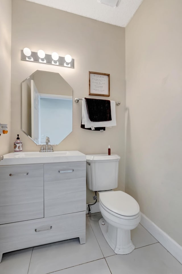 bathroom with vanity, tile patterned floors, and toilet