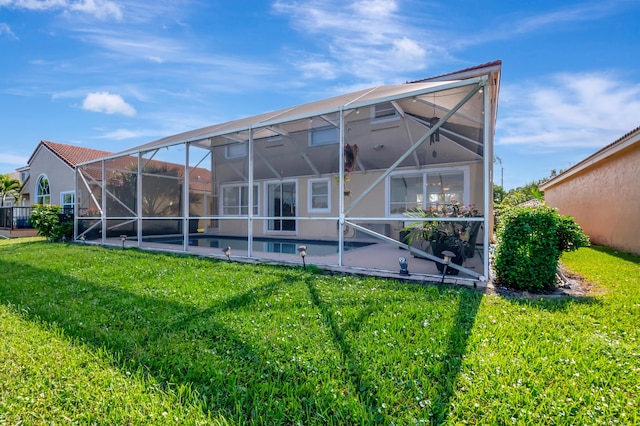 rear view of house featuring a yard and a lanai