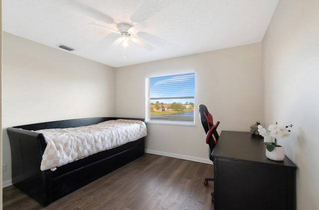 bedroom featuring dark hardwood / wood-style floors and ceiling fan