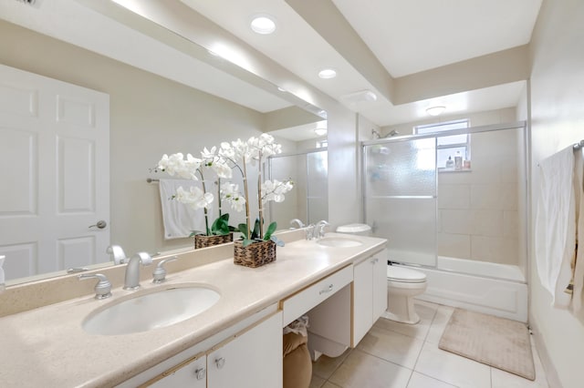 full bathroom featuring tile patterned floors, toilet, combined bath / shower with glass door, and vanity