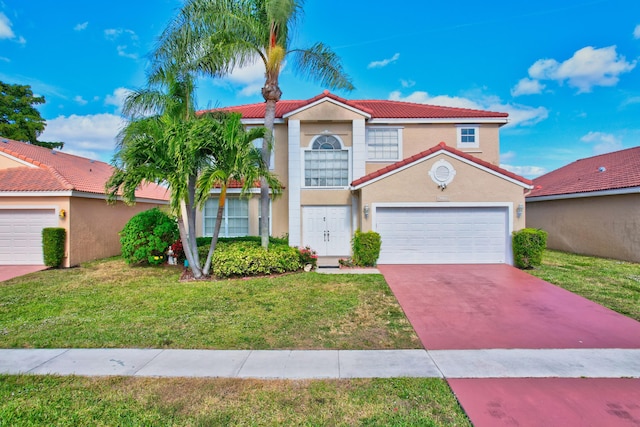 mediterranean / spanish home with a garage and a front lawn