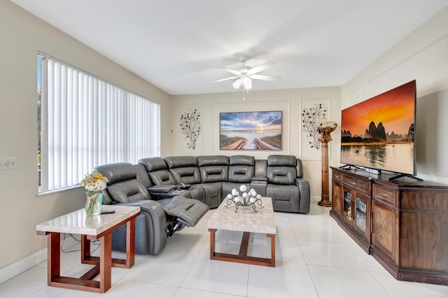 living room featuring light tile patterned flooring, a textured ceiling, and ceiling fan