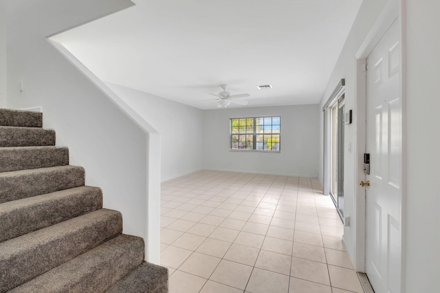 tiled entryway with ceiling fan