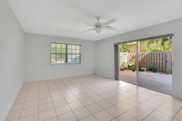 tiled spare room with ceiling fan and a healthy amount of sunlight