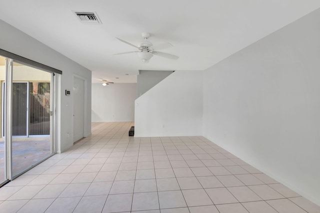 tiled spare room with ceiling fan