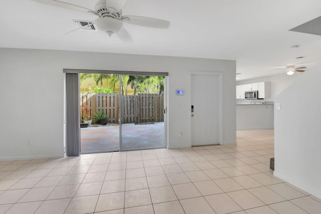 unfurnished room with ceiling fan and light tile patterned floors