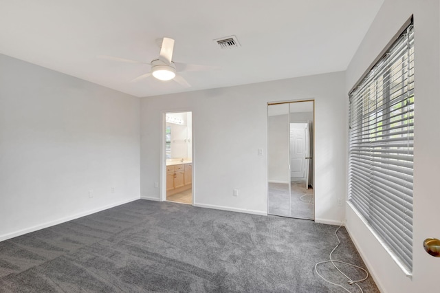 unfurnished room featuring dark colored carpet and ceiling fan