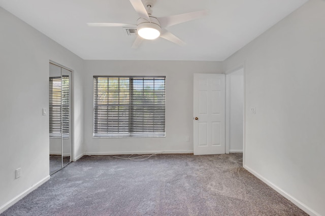 carpeted spare room with ceiling fan