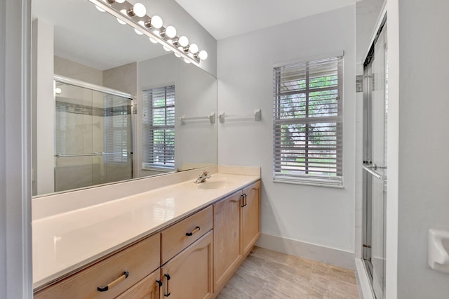 bathroom with tile patterned floors, vanity, and walk in shower