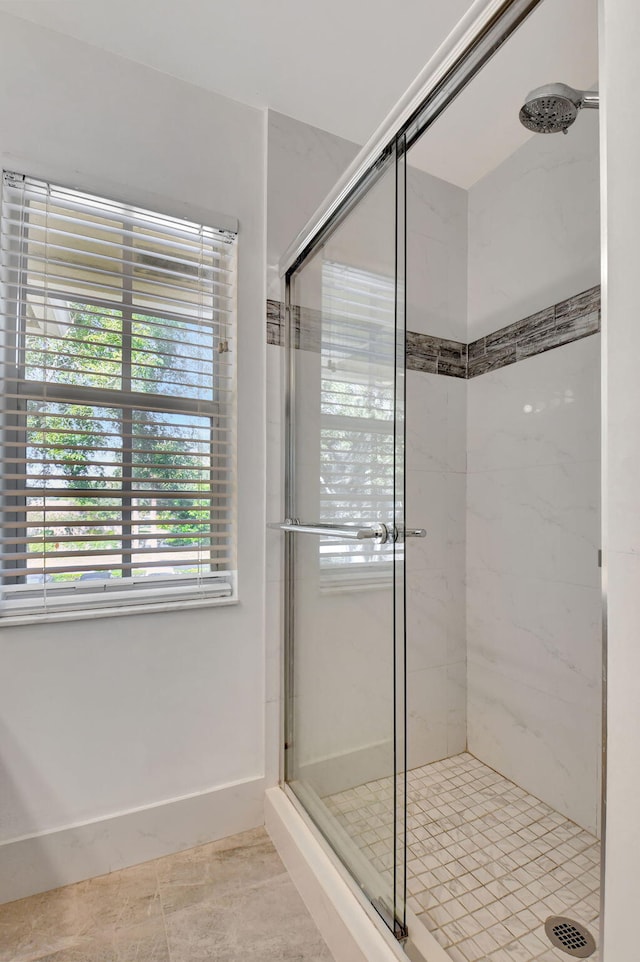 bathroom featuring tile patterned floors and a shower with shower door