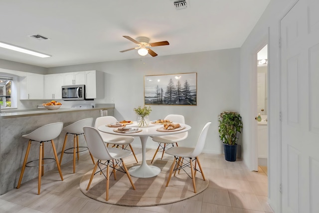 dining space featuring ceiling fan