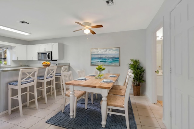 tiled dining room featuring ceiling fan