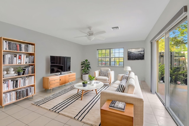 living room with light tile patterned floors and ceiling fan