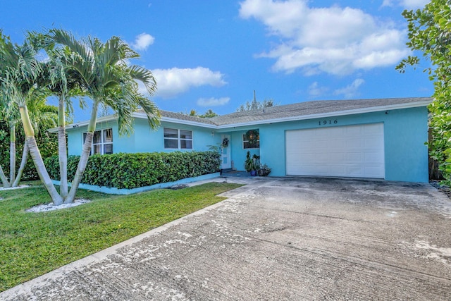 single story home with a garage and a front yard