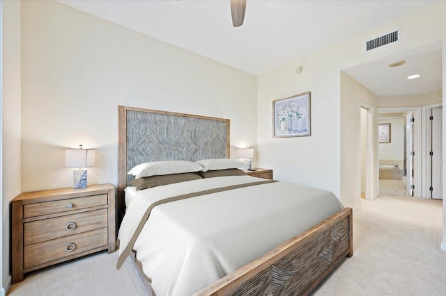 carpeted bedroom with connected bathroom and ceiling fan