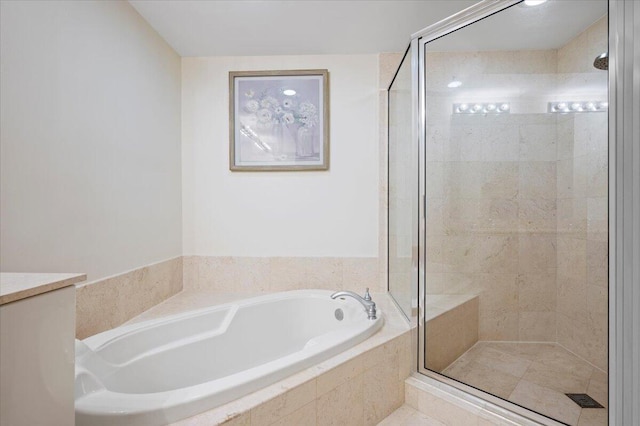 bathroom featuring separate shower and tub