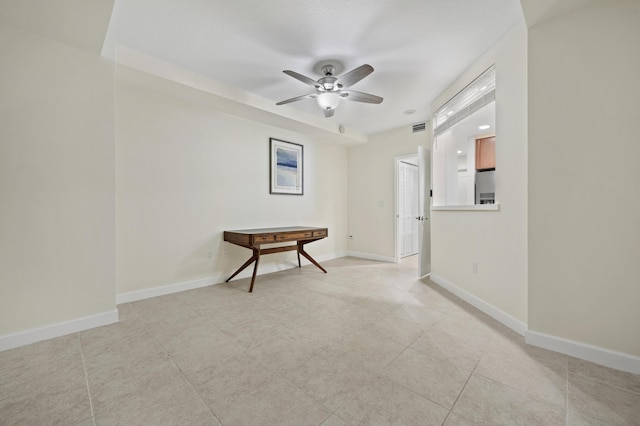 tiled empty room with ceiling fan