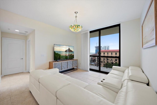 living room featuring light tile patterned floors and an inviting chandelier