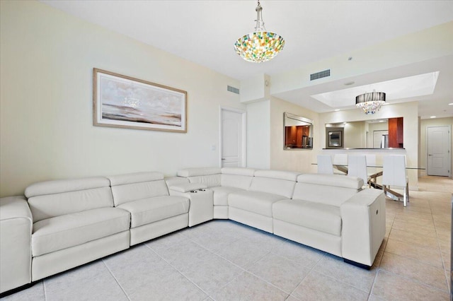 living room featuring an inviting chandelier and light tile patterned flooring