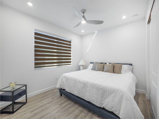 bedroom with light wood-type flooring, baseboards, and recessed lighting