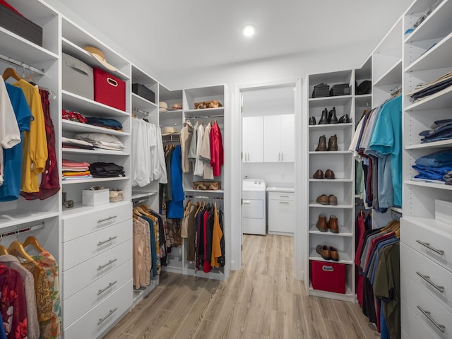 walk in closet featuring washer / clothes dryer and light hardwood / wood-style flooring