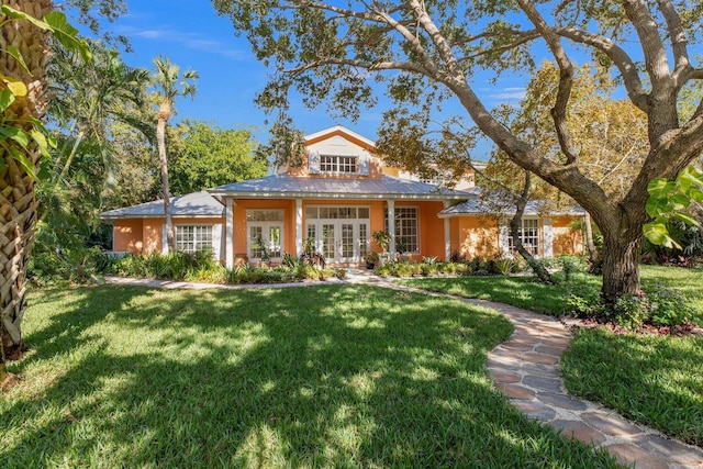 view of front of property with a front yard and french doors