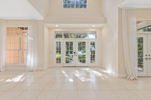 doorway featuring plenty of natural light, light tile patterned floors, and french doors