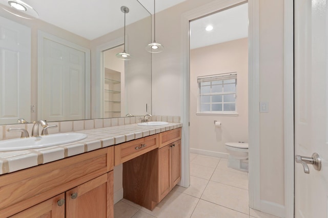 bathroom with toilet, tile patterned floors, and vanity