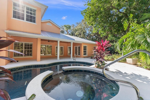 view of pool featuring french doors, a patio, and an in ground hot tub