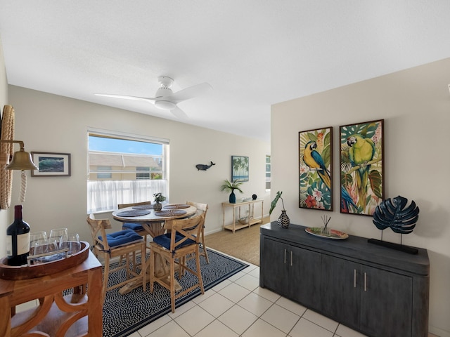 tiled dining room featuring ceiling fan