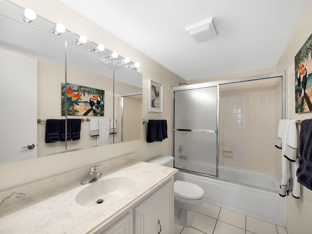 full bathroom featuring tile patterned floors, vanity, toilet, and bath / shower combo with glass door