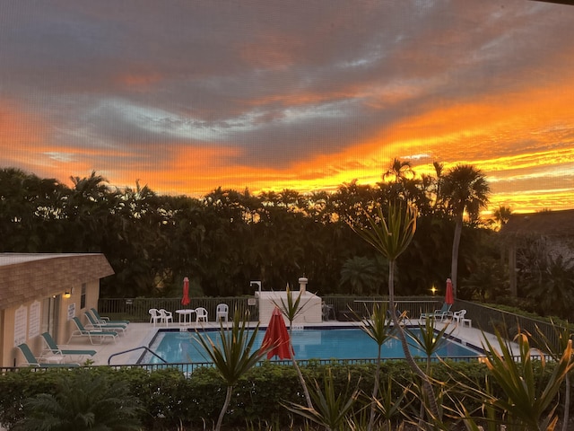 view of pool at dusk