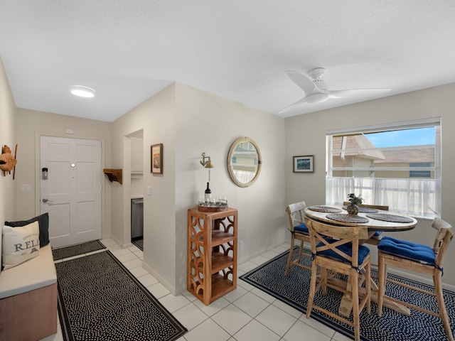 tiled dining space with ceiling fan