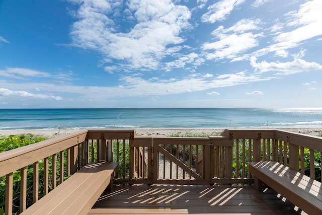 wooden terrace with a water view and a beach view