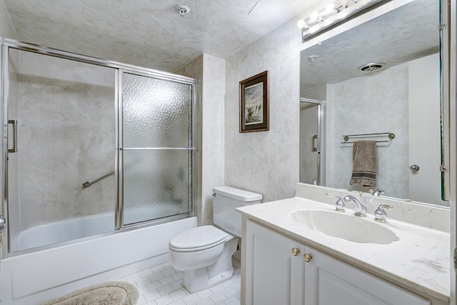 full bathroom with tile patterned flooring, vanity, enclosed tub / shower combo, and toilet