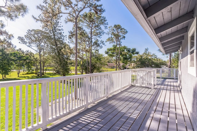 wooden deck featuring a yard