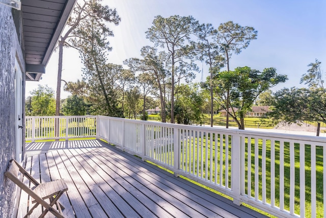 wooden terrace with a lawn