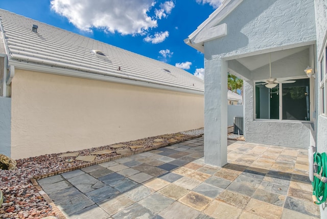 view of patio / terrace featuring ceiling fan and central AC unit