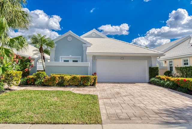 view of front of property featuring a garage and a front lawn