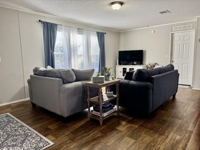 living room featuring a textured ceiling, dark hardwood / wood-style flooring, and crown molding